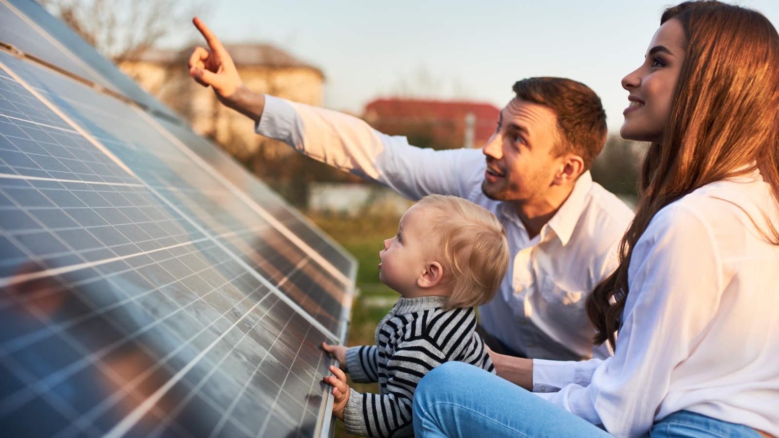 young family looking at solar panels