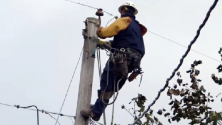 employee working on utility pole