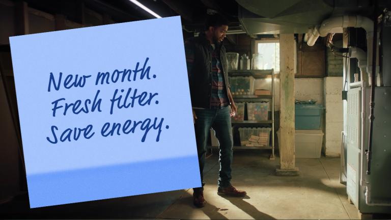 man next to furnace sticky note new month fresh filter save energy