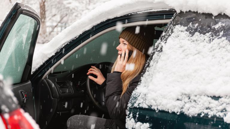 Woman in car while snowing