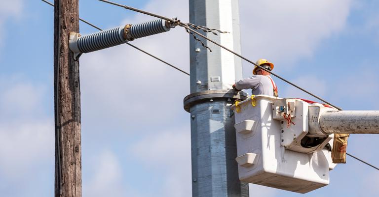 Utility worker, working on pole