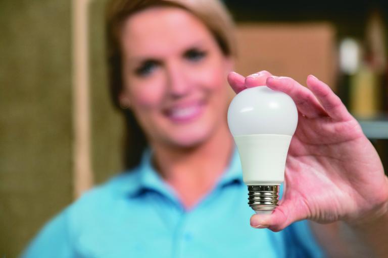 Woman holding light bulb.
